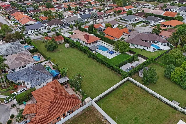 an aerial view of a residential houses with outdoor space