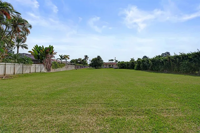 a view of yard with swimming pool and green space