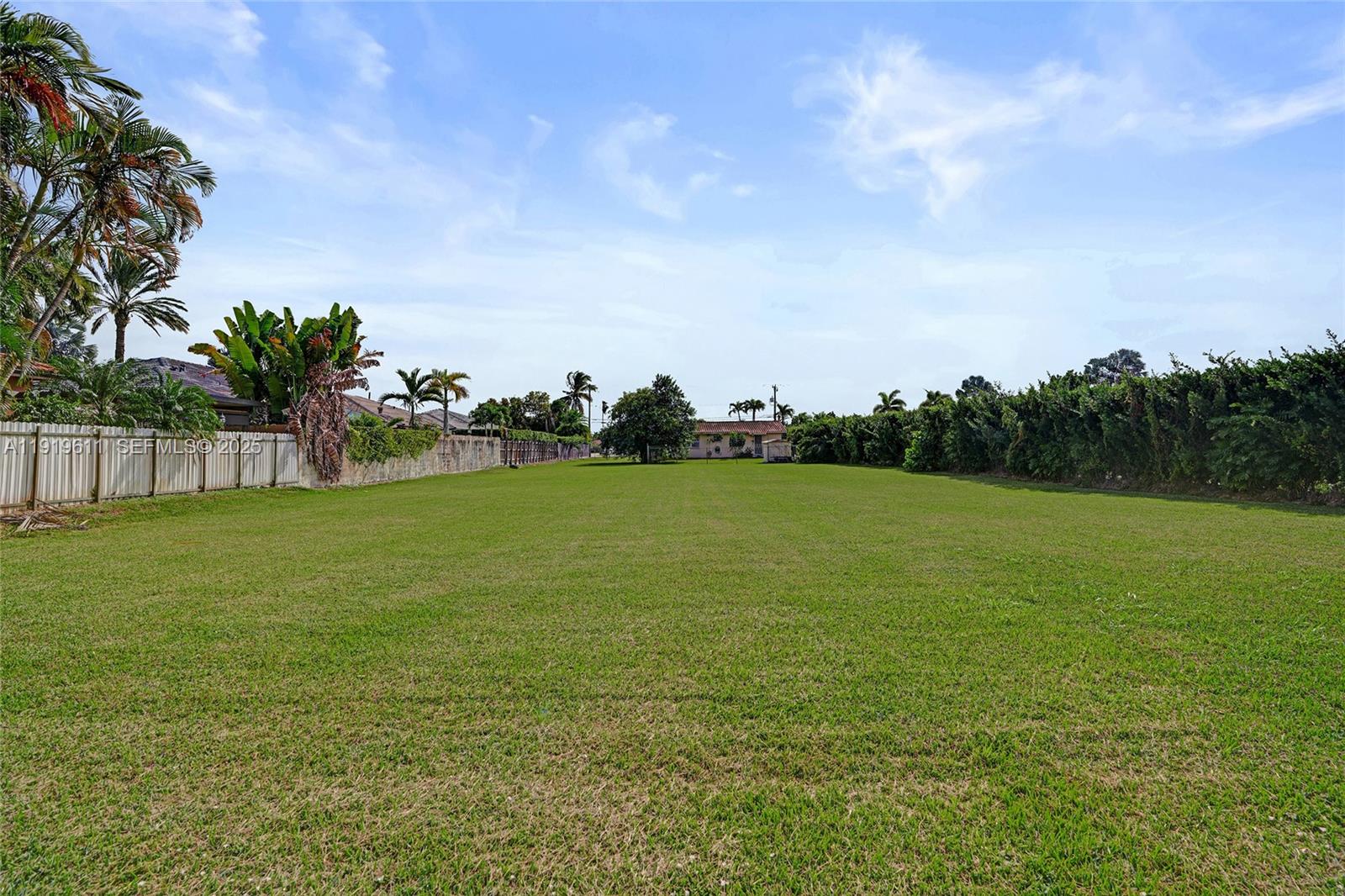 13401 Southwest 38th Street Miami, FL 33175 - Photo 3 of 45 a view of a green field with wooden fence
