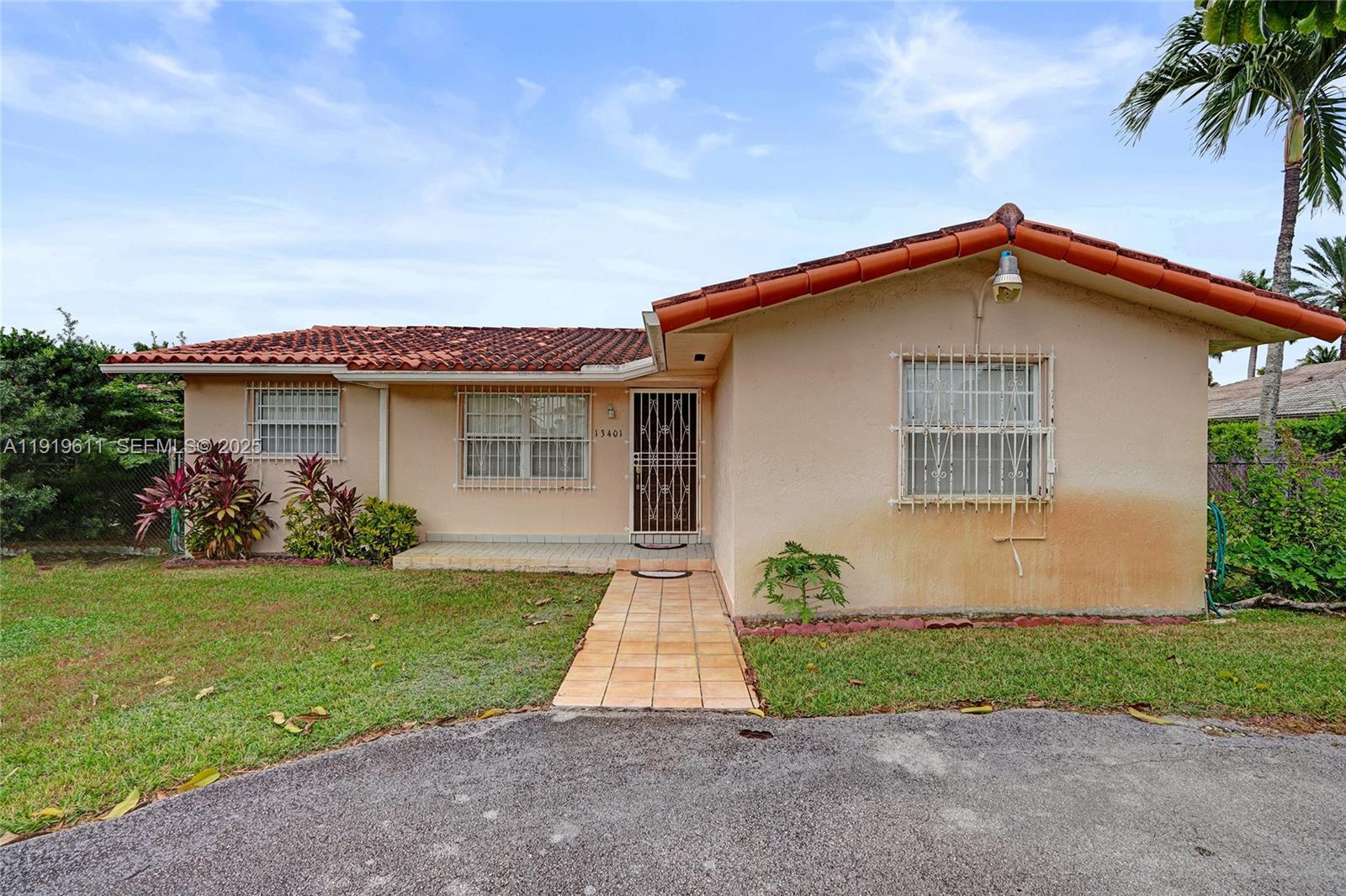13401 Southwest 38th Street Miami, FL 33175 - Photo 33 of 45 a front view of a house with a yard and garage