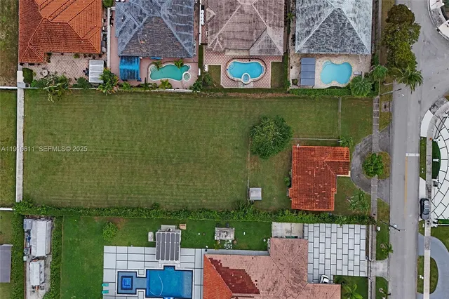 an aerial view of multiple houses with yard