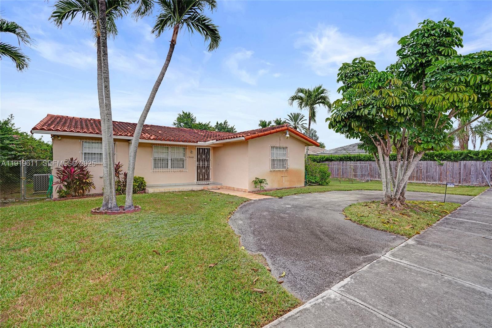 13401 Southwest 38th Street Miami, FL 33175 - Photo 36 of 45 a front view of a house with a garden