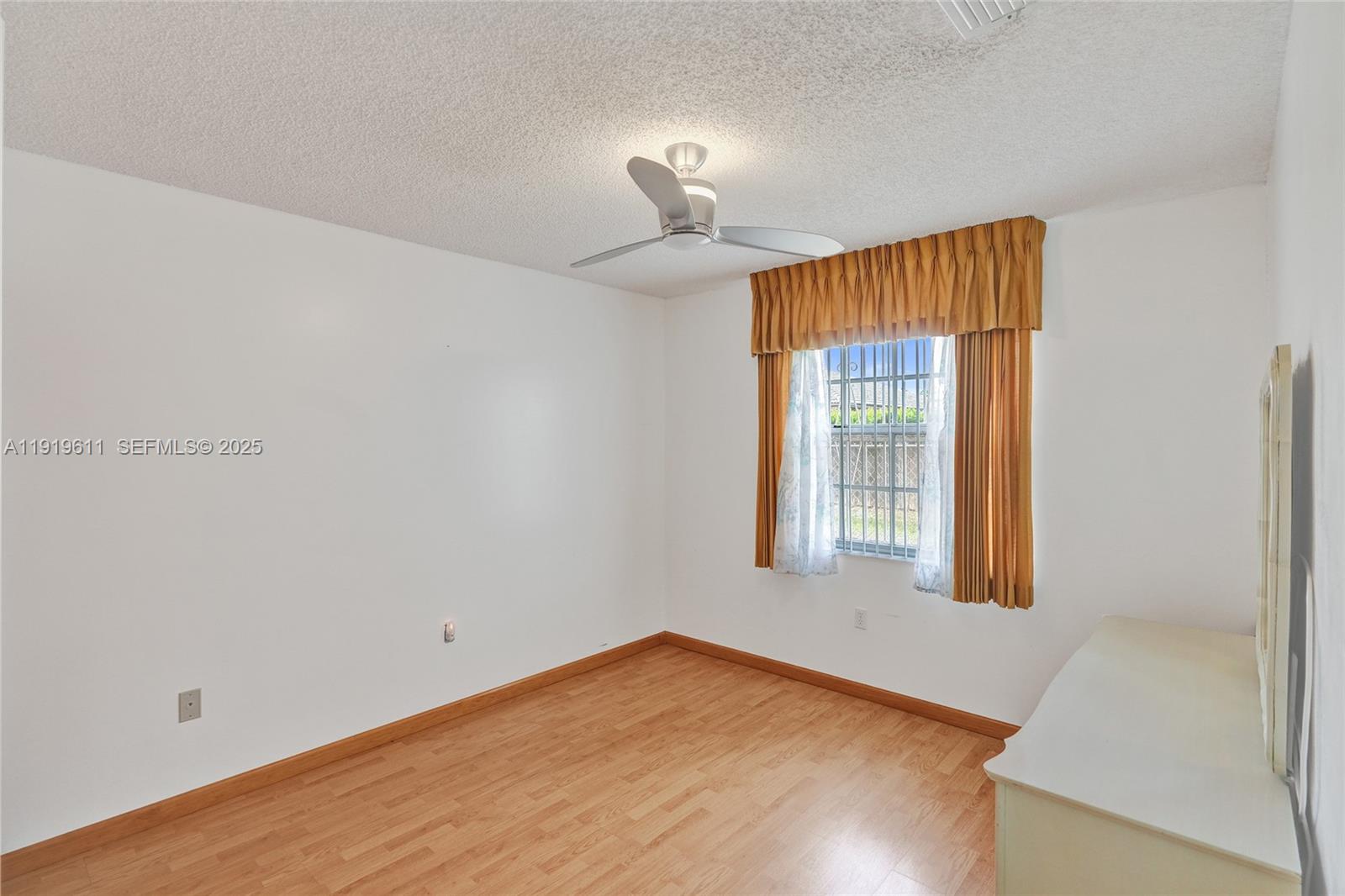 13401 Southwest 38th Street Miami, FL 33175 - Photo 40 of 45 a view of an empty room with window and wooden floor