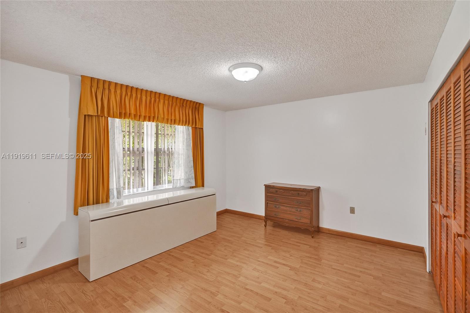 13401 Southwest 38th Street Miami, FL 33175 - Photo 44 of 45 an empty room with wooden floor and windows