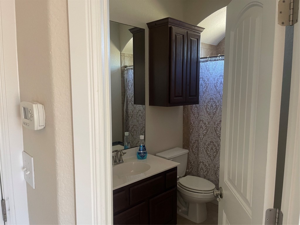 6708 Menchaca Road, Unit 11 Austin, TX 78745 - Photo 6 of 8 a bathroom with a sink a toilet and shower