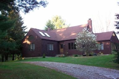 47 West Center Road West Stockbridge, MA 01266 - Photo 1 of 2 a front view of a house with a garden and plants