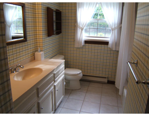 86 Purgatory Road Sutton, MA 01590 - Photo 14 of 16 a bathroom with a granite countertop toilet a sink and mirror