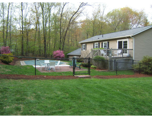 86 Purgatory Road Sutton, MA 01590 - Photo 7 of 16 a view of a house with a backyard and a patio