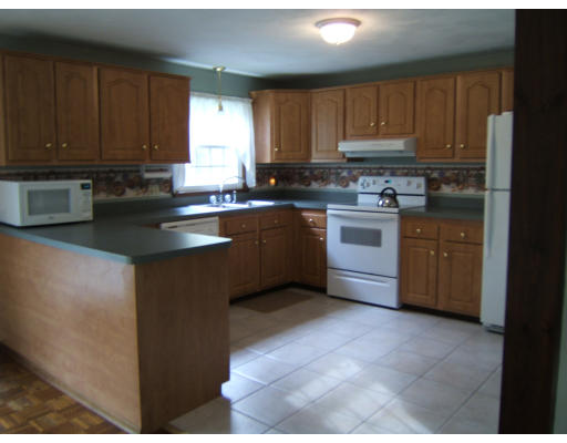 86 Purgatory Road Sutton, MA 01590 - Photo 10 of 16 a kitchen with stainless steel appliances granite countertop a stove a sink dishwasher and a refrigerator