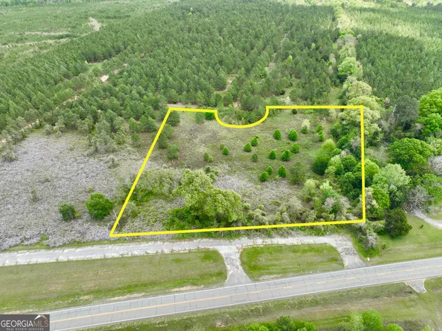 a view of a green field with lots of trees