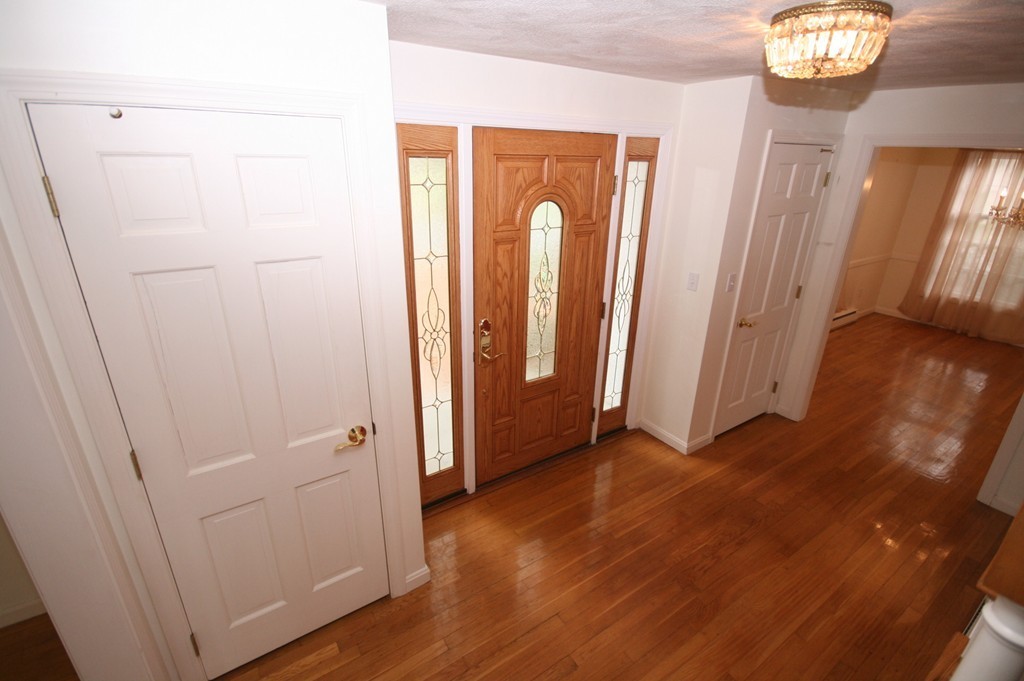 1 Whiting Road Framingham, MA 01701 - Photo 4 of 28 a view of a hallway with wooden floor and staircase