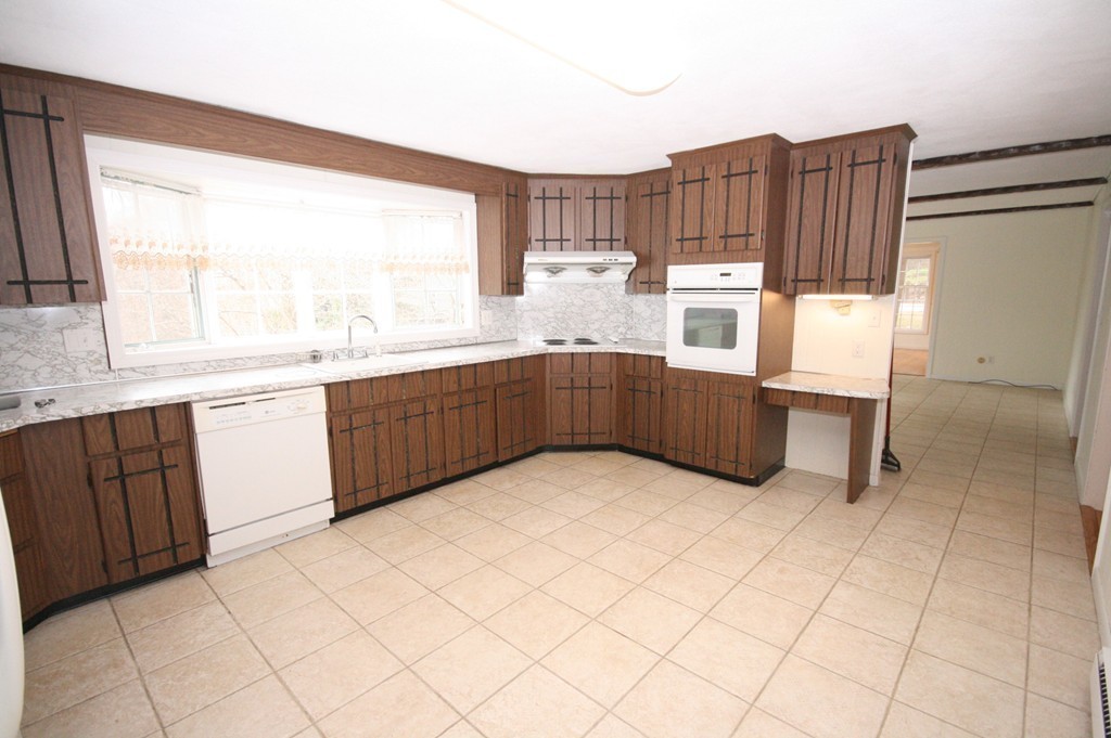 1 Whiting Road Framingham, MA 01701 - Photo 9 of 28 a kitchen with stainless steel appliances a sink and cabinets