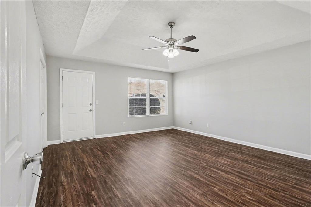 6279 Avery Street Southwest Covington, GA 30014 - Photo 12 of 21 a view of a big room with wooden floor closet and windows