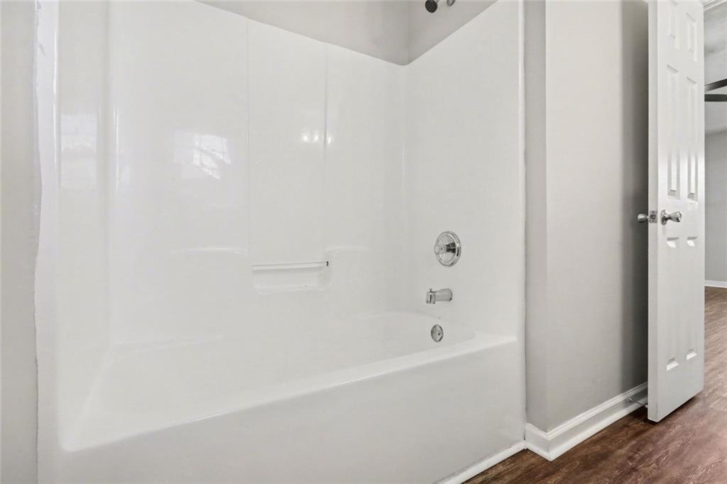 6279 Avery Street Southwest Covington, GA 30014 - Photo 18 of 21 a bathroom with a bathtub