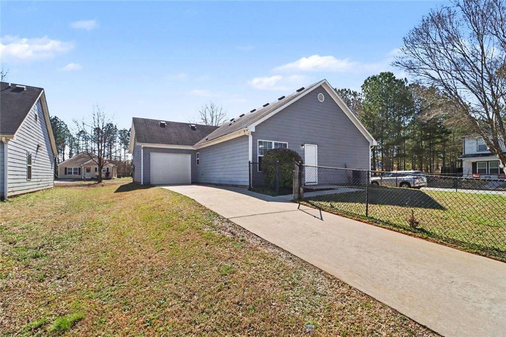 6279 Avery Street Southwest Covington, GA 30014 - Photo 20 of 21 a house view with swimming pool and tall buildings