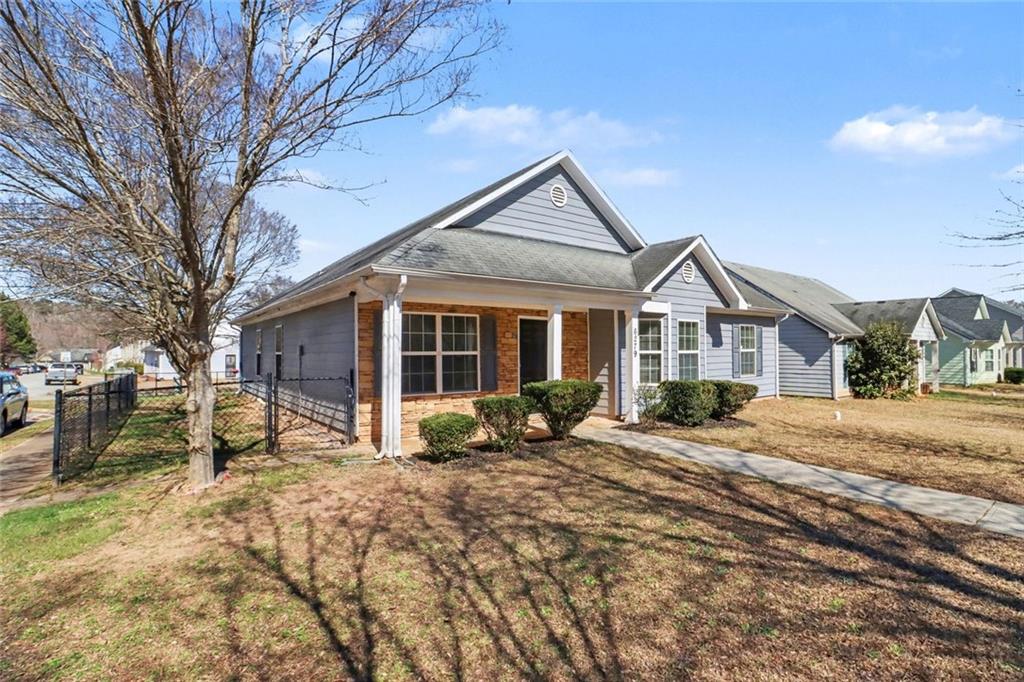 6279 Avery Street Southwest Covington, GA 30014 - Photo 2 of 21 a front view of a house with a yard covered in snow