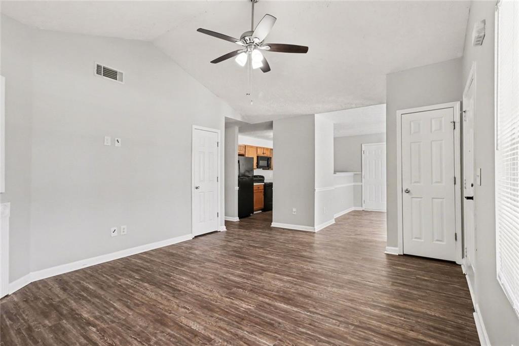 6279 Avery Street Southwest Covington, GA 30014 - Photo 6 of 21 wooden floor in an empty room with a window