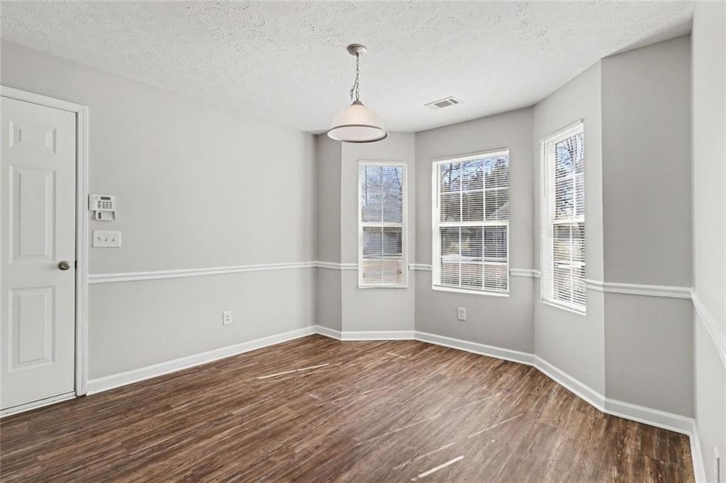 6279 Avery Street Southwest Covington, GA 30014 - Photo 7 of 21 a view of empty room with wooden floor and fan