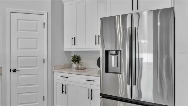 a kitchen with cabinets stainless steel appliances a sink and a microwave