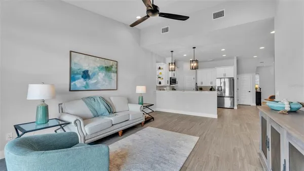 a living room with furniture and a potted plant