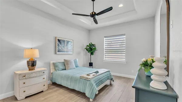 a bedroom with bed and a potted plant