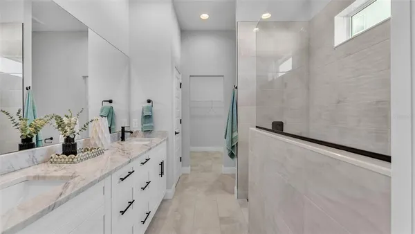 a bathroom with a double vanity sink and a mirror