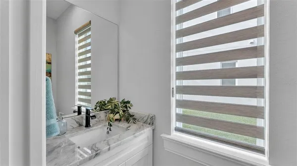 a view of a room that has a window and a chair
