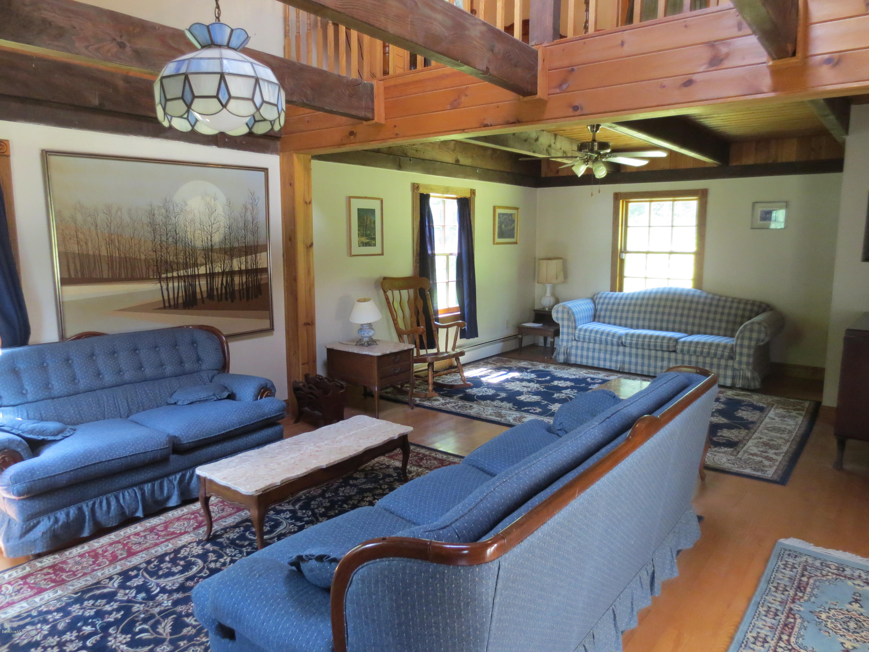 87 Crane Road Chester, MA 01011 - Photo 3 of 16 a living room with furniture a chandelier and a dining table