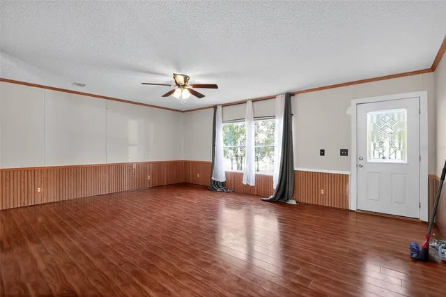 a view of hallway with stairs and furniture