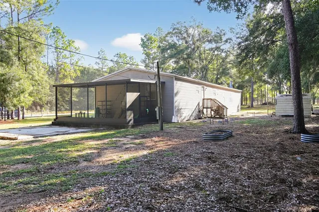 a view of a yard with a house and a tree