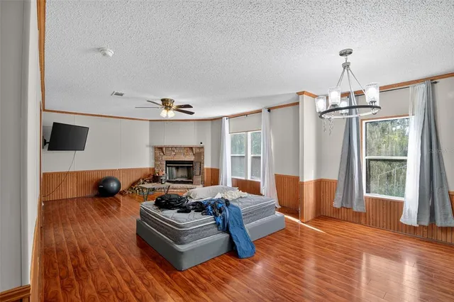 a view of a bathroom with a toilet a sink and wooden floor