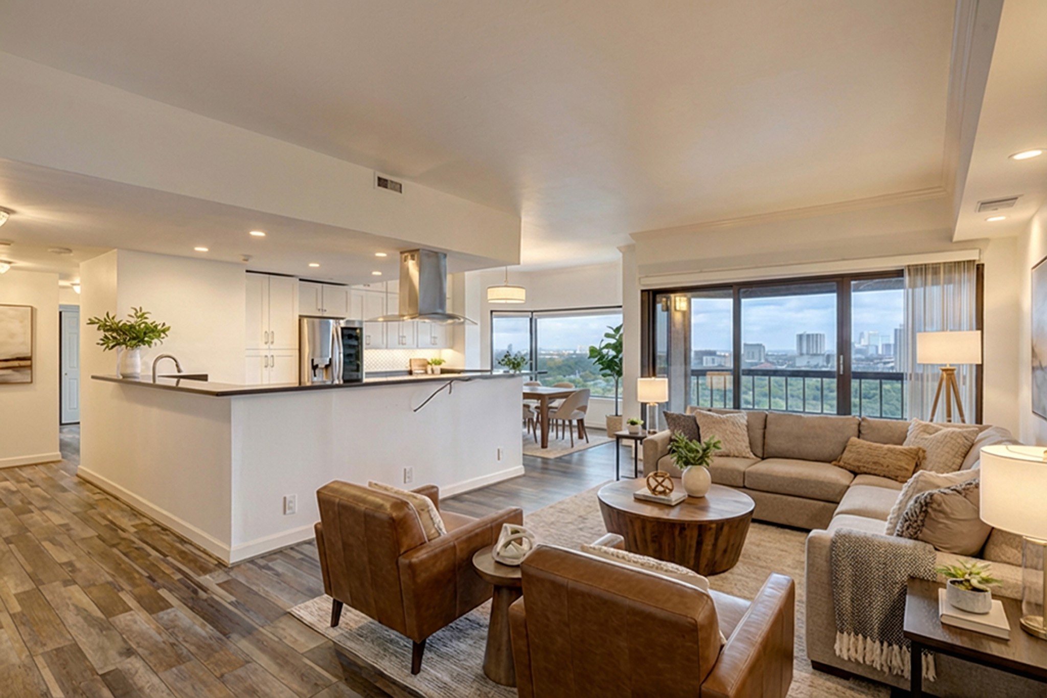 a living room with furniture wooden floor and a large window