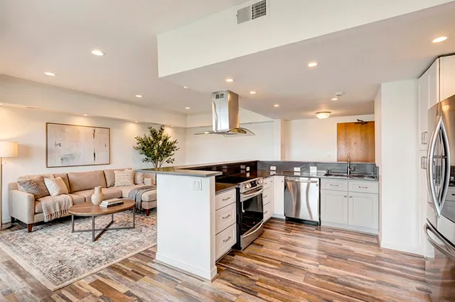 a kitchen with stainless steel appliances granite countertop a stove a sink and a refrigerator