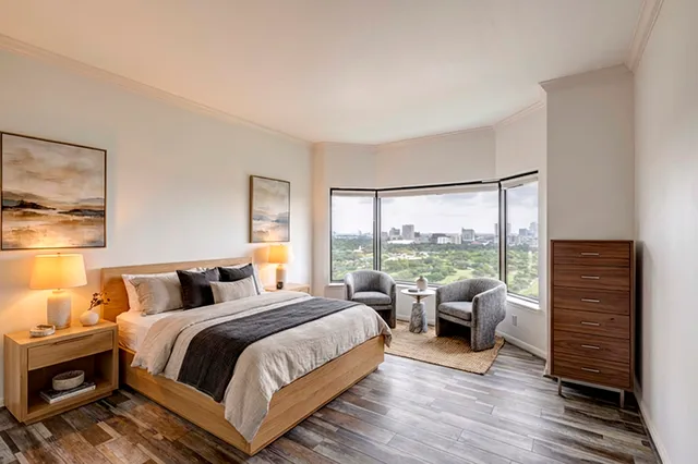 a bedroom with a bed and a large window