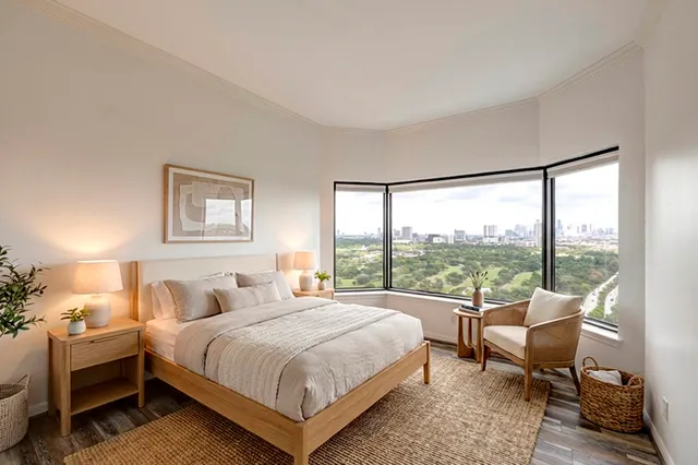 a bedroom with a bed and a large window