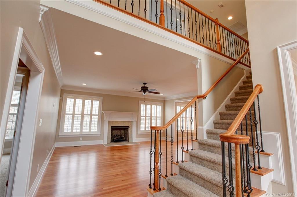 272 Hemmingway Lane Fort Mill, SC 29708 - Photo 2 of 24 a view of staircase with wooden floor and a fireplace