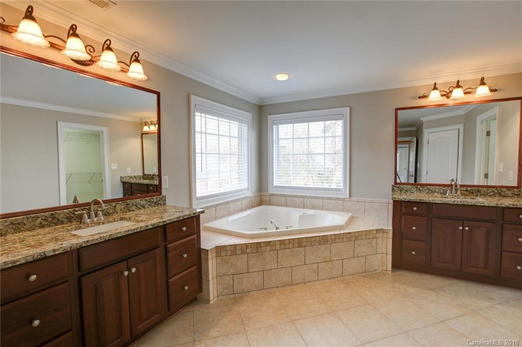 272 Hemmingway Lane Fort Mill, SC 29708 - Photo 11 of 24 a spacious bathroom with a granite countertop tub sink and mirror