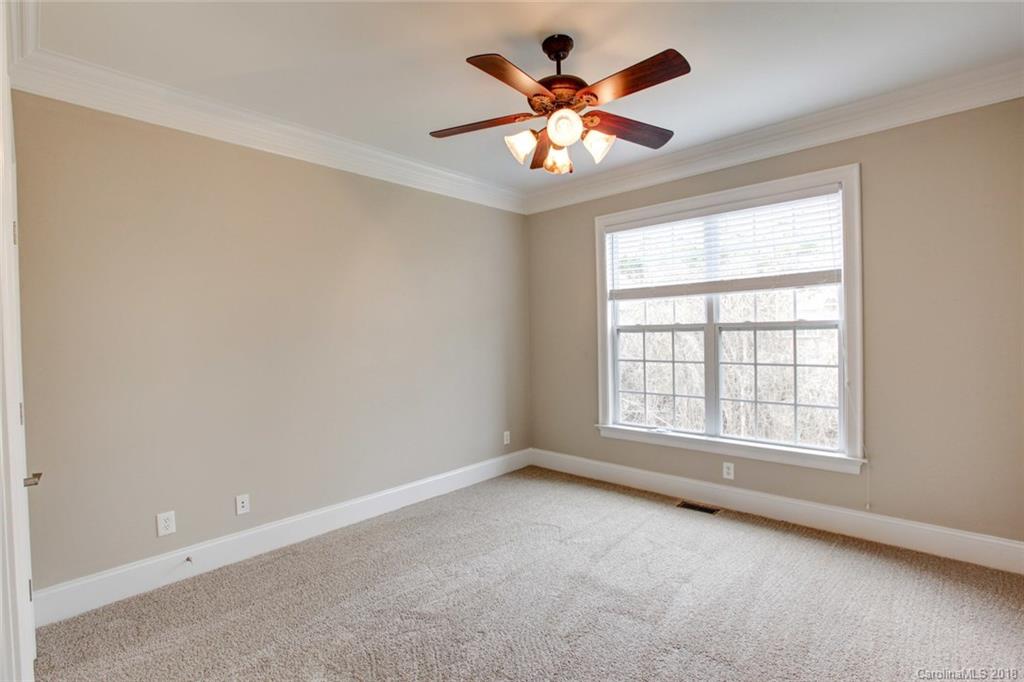 272 Hemmingway Lane Fort Mill, SC 29708 - Photo 17 of 24 an empty room with chandelier fan and windows