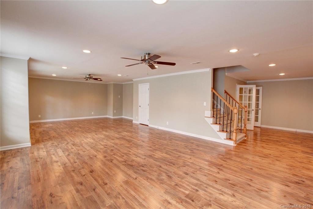 272 Hemmingway Lane Fort Mill, SC 29708 - Photo 19 of 24 a view of an empty room with wooden floor and a ceiling fan