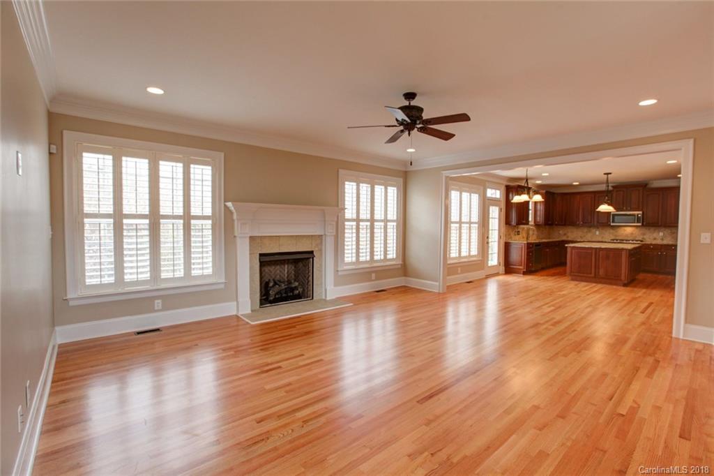 272 Hemmingway Lane Fort Mill, SC 29708 - Photo 3 of 24 a view of a kitchen with a fireplace a sink and wooden floor