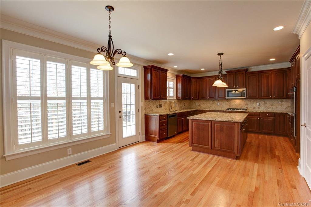 272 Hemmingway Lane Fort Mill, SC 29708 - Photo 4 of 24 a large kitchen with wooden floors and stainless steel appliances