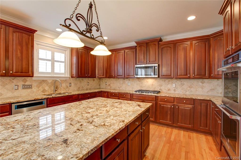 272 Hemmingway Lane Fort Mill, SC 29708 - Photo 5 of 24 a kitchen with stainless steel appliances granite countertop wooden cabinets a sink and dishwasher