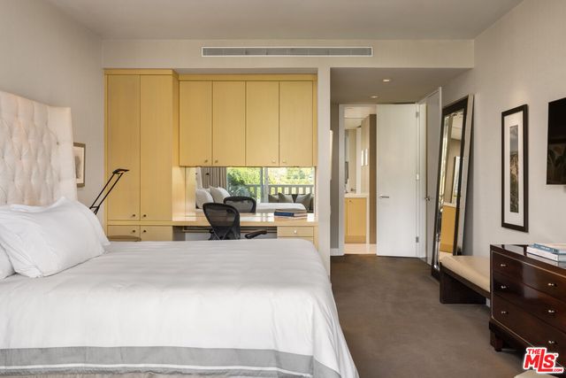 a living room with furniture and large windows