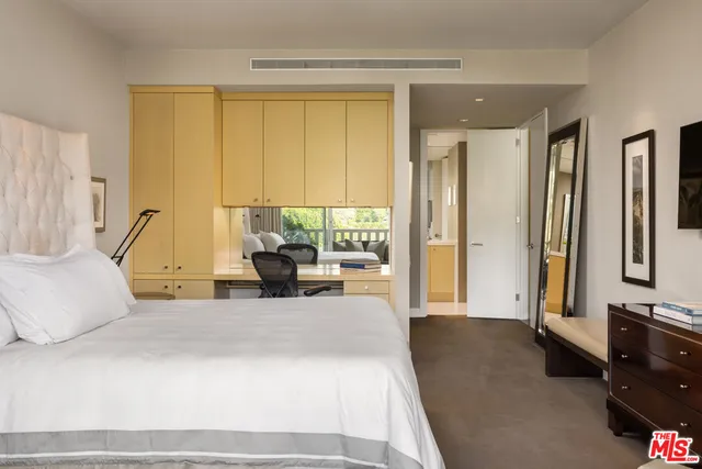 a living room with furniture and large windows