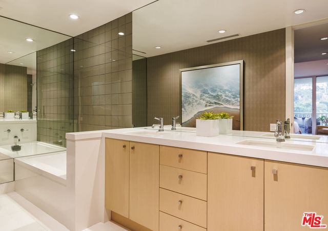 a bathroom with a sink double vanity and a bathtub