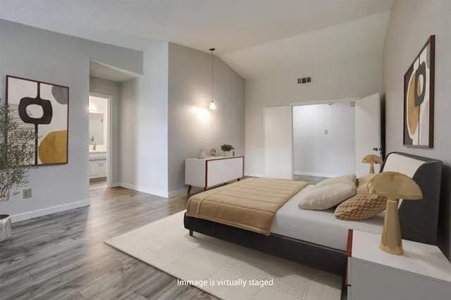 a bedroom with a bed and wooden floor