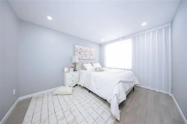 a large white bed in a white room