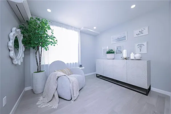 a bedroom with furniture and a potted plant