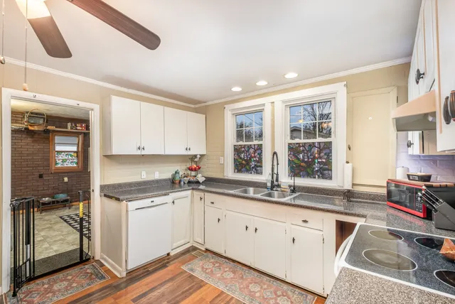 a kitchen with a sink stove and cabinets
