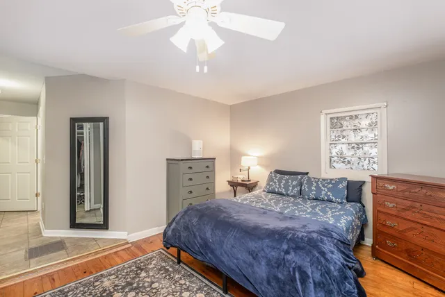 a bedroom with a bed and a dresser